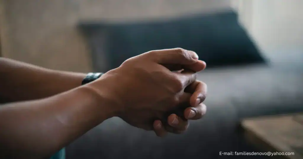 Close up of person’s hands clasped in a meditative pose representing mental health, counseling services, anxiety, stress, depression, emotional stability, importance of reflection and well-being. 